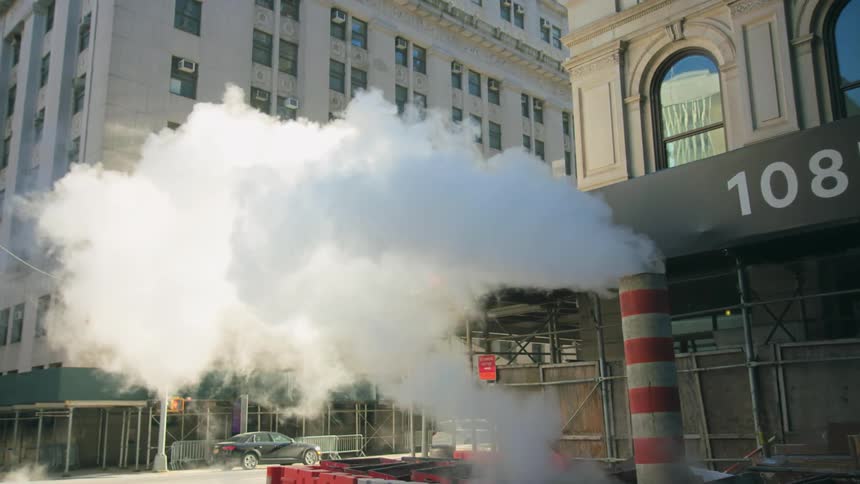 Smoke and smog are coming out of pipes in a city