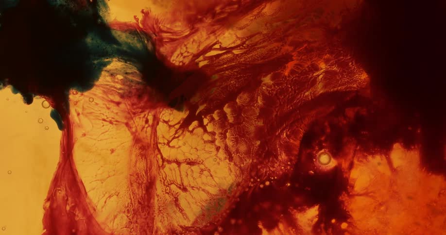 The colors swirl and move in the yellow liquid