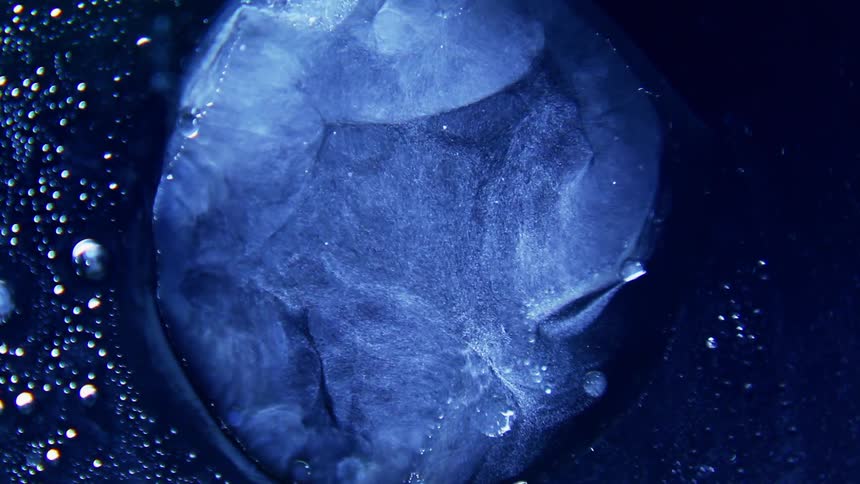 A blue viscous fluid forms into different shapes