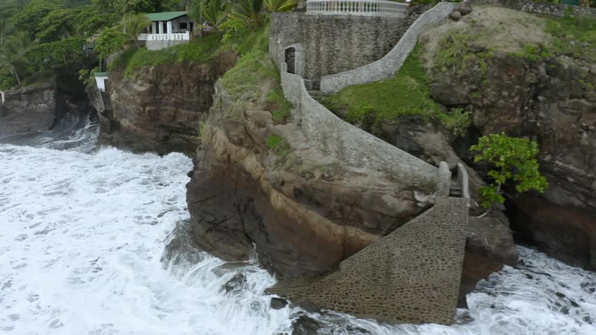 Waves crash against a rocky shore