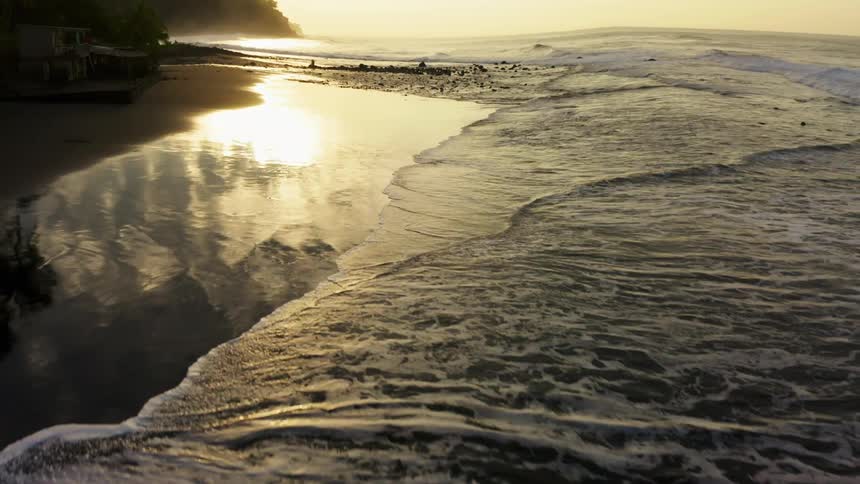 The sun is setting on the shore