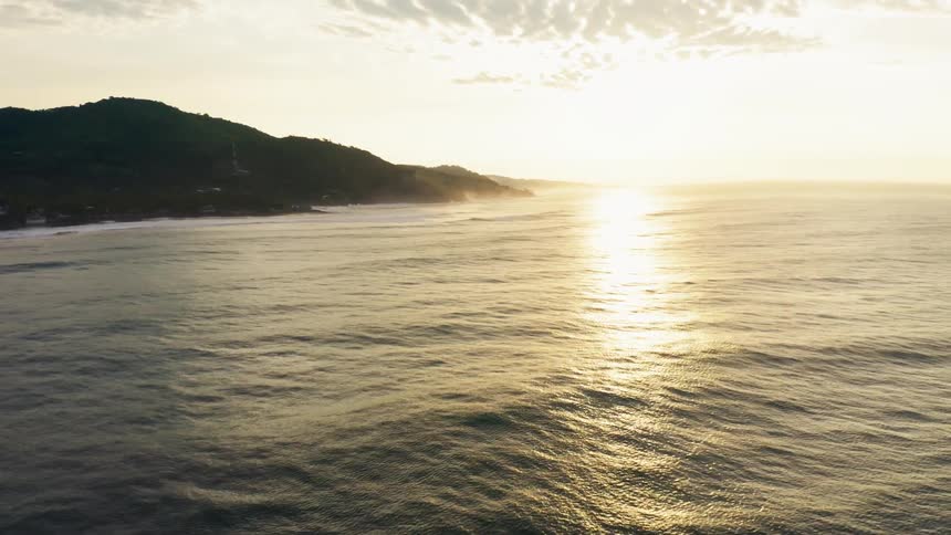The sun rising on the ocean