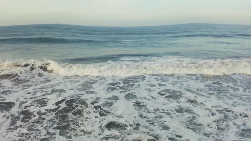 The rough waves pour onto the shore