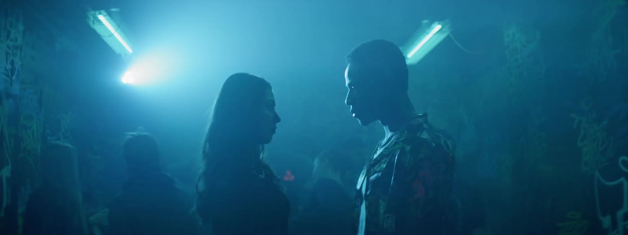 Couple stare at each other on underground party