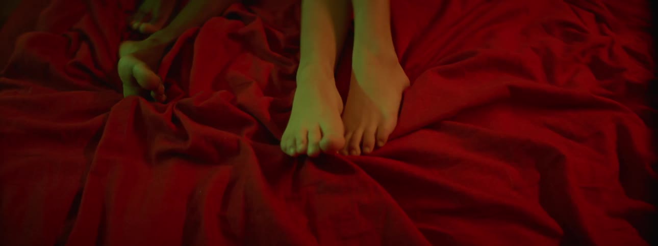 People lay motionless on a bed