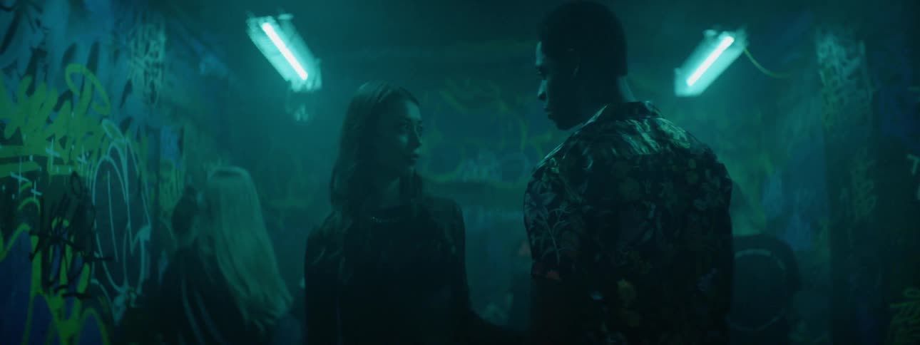 Man and woman face each other on the dance floor