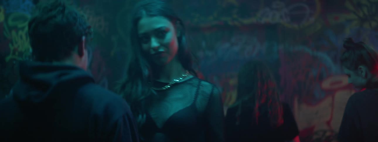 People dancing in a club with strobing lights
