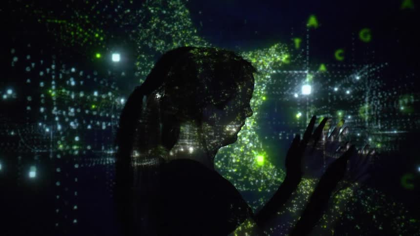 Woman stands under projected glittering image examining hands