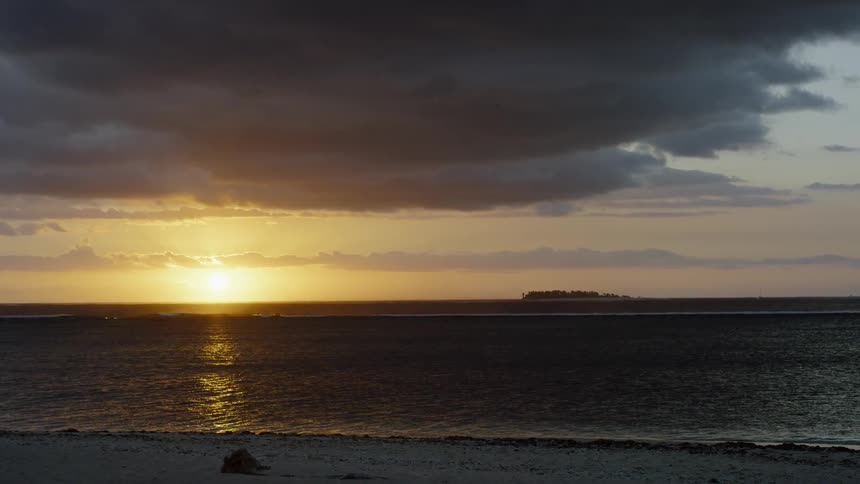 The sun sets over the ocean