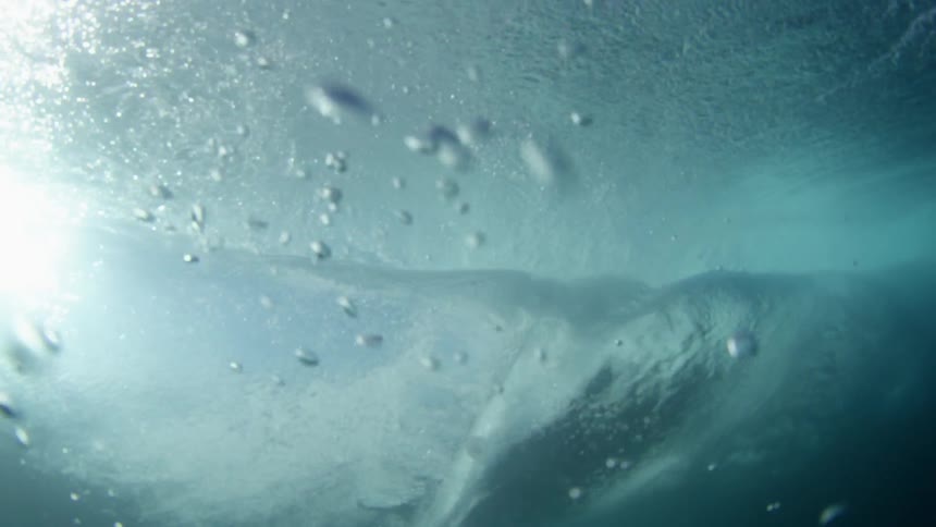 An underwater view of a large ocean wave