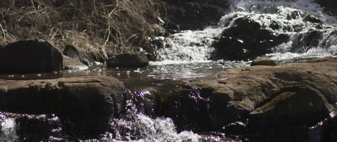Water pours over rock formations