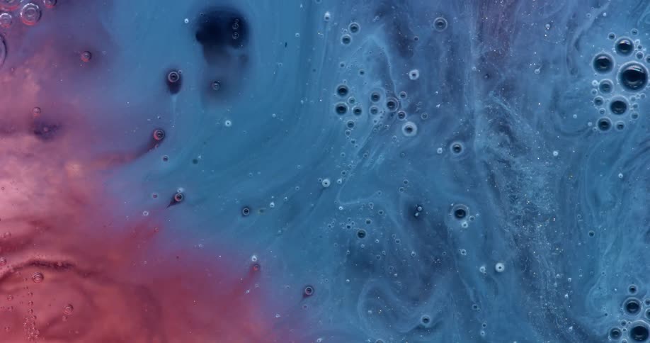 Blue and red paint flows over a surface