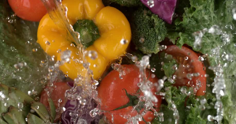 Water splashing down on fresh vegetables