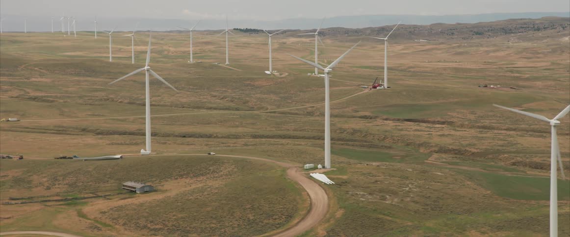 Wind turbines spin in an open field