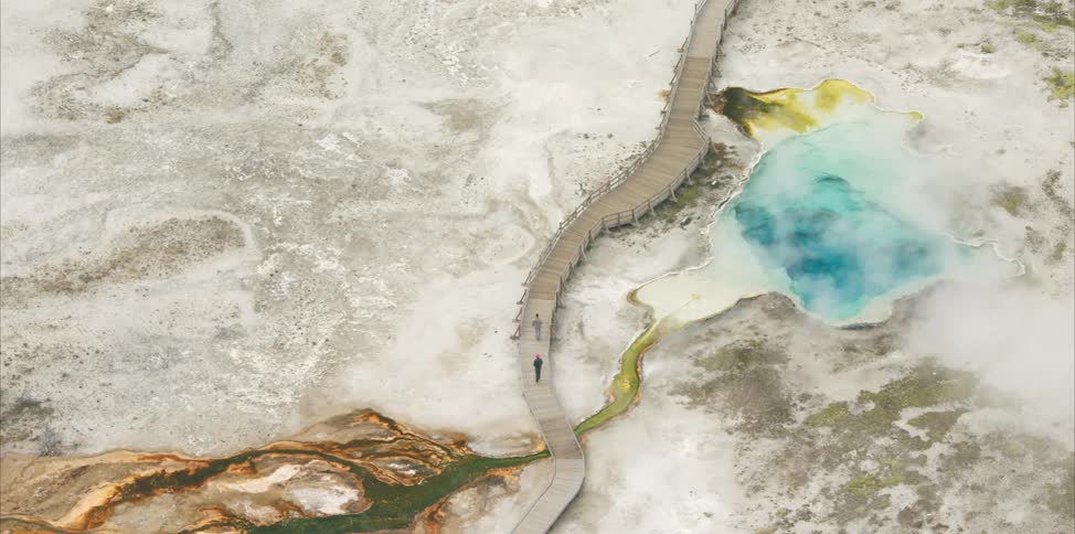 Steam releasing from blue and yellow sulfur pools