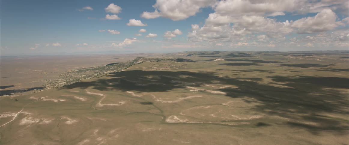 An aerial view of a desert area is displayed