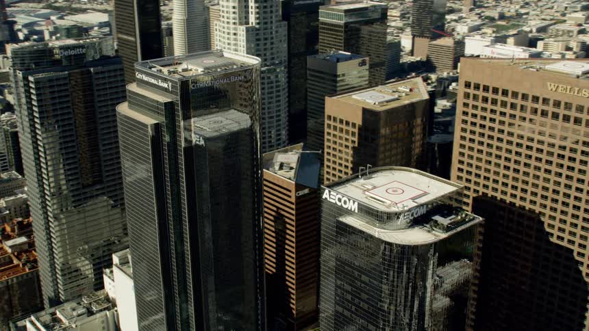 A very large city full of buildings and reflective skyscrapers