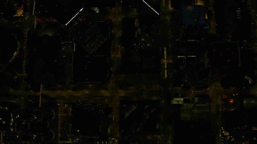 Lights illuminate a city below