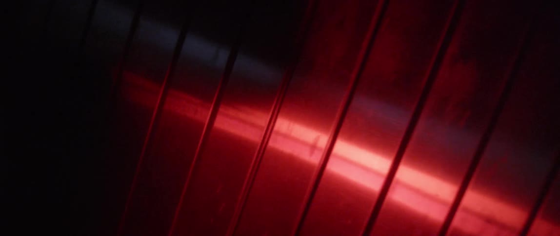 Red light reflects off an accordion style garage door