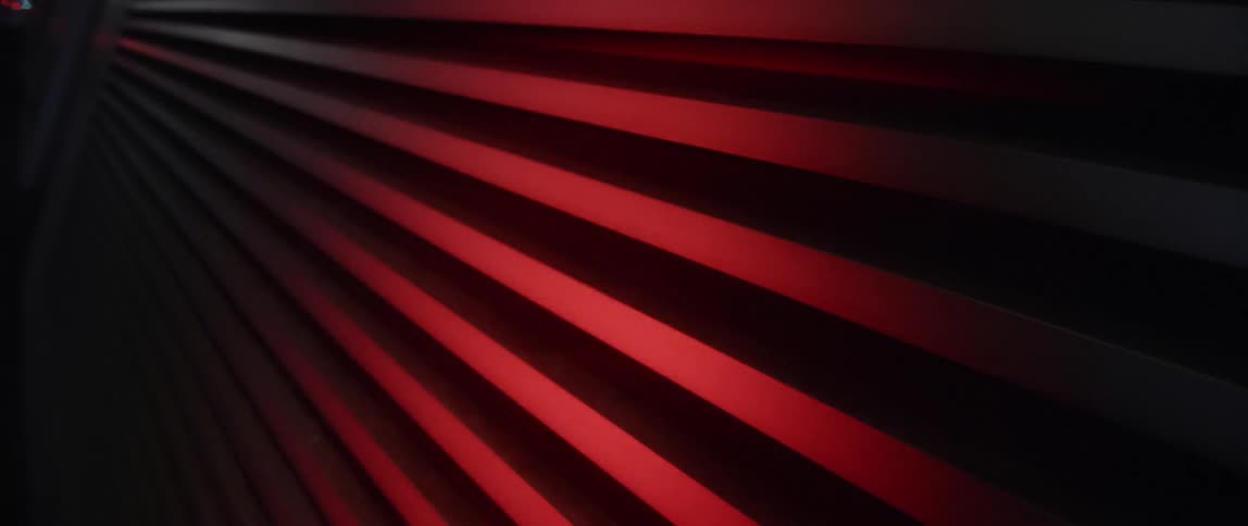 A flashing red light reflects off the door of a storage container
