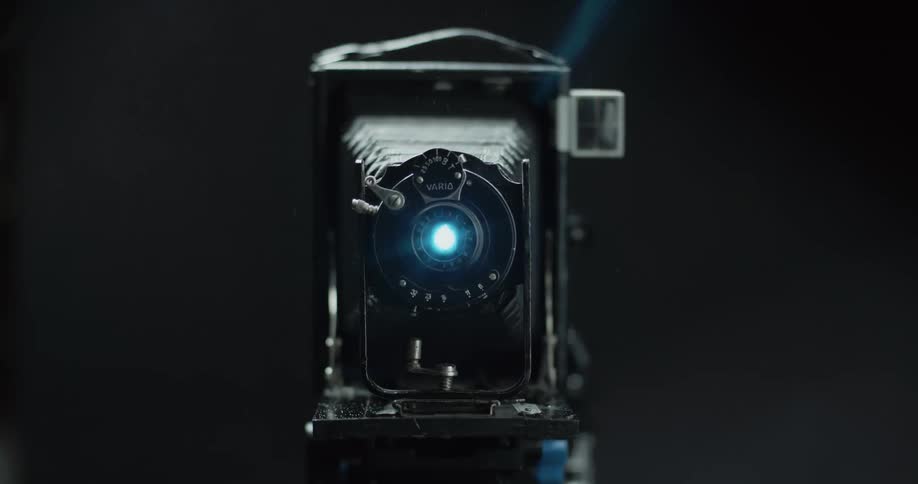 Light comes out of the lens of a vintage camera