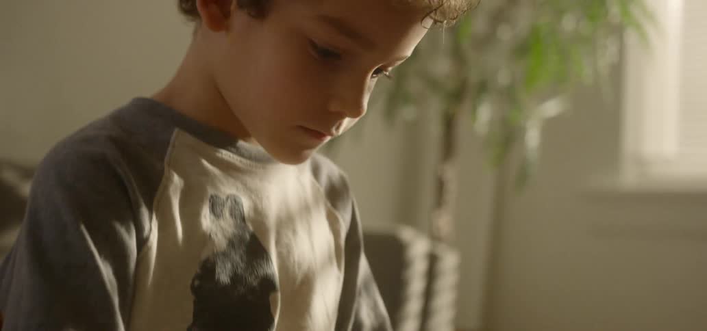 A child is drawing with a pen