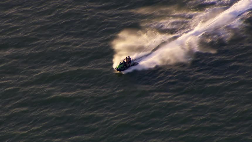 Two people riding a jet ski