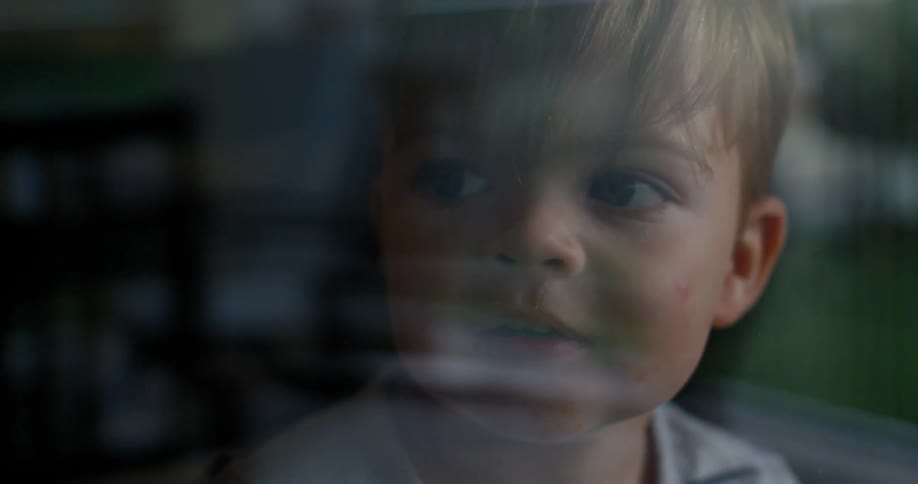 A child looks out a window