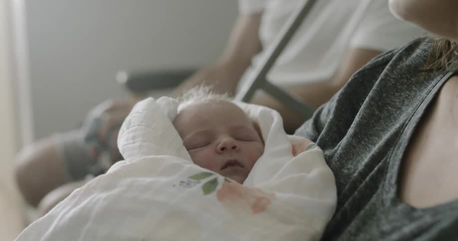 A newborn is held