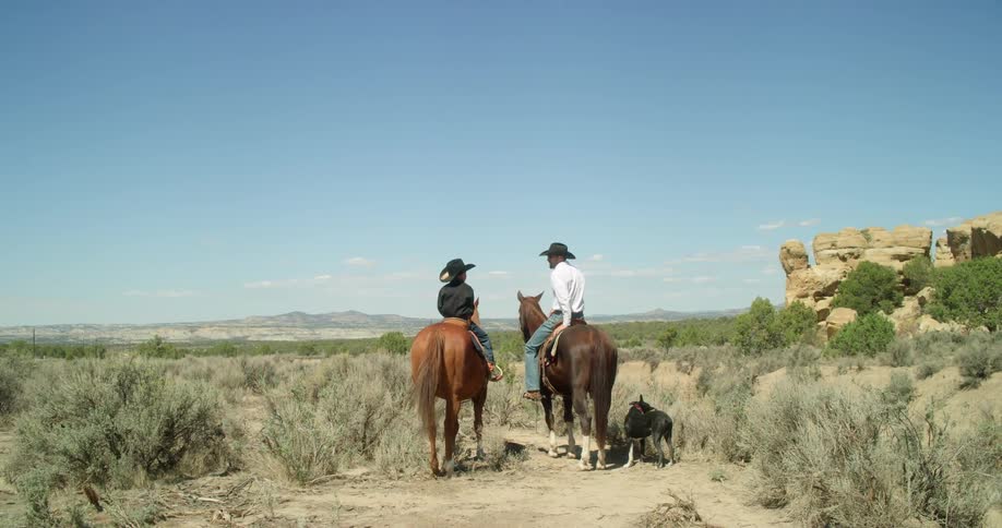 Couple taking a break while horseback riding in the desert