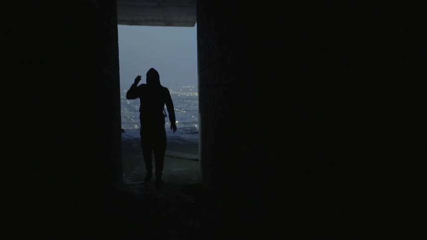 A man in a hoodie walking outside
