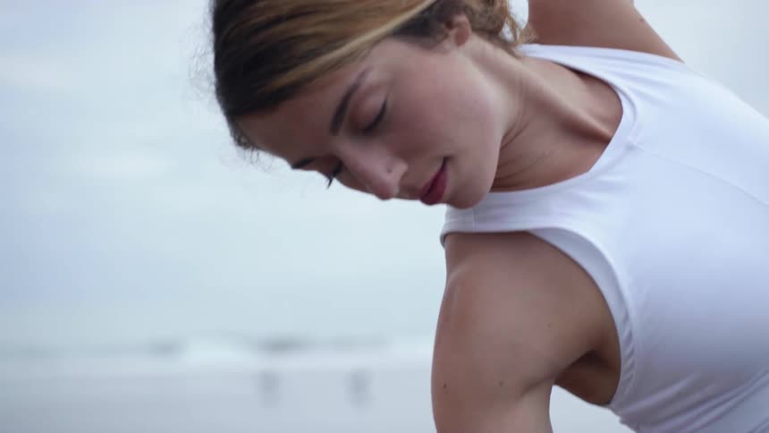A woman is stretching outdoors