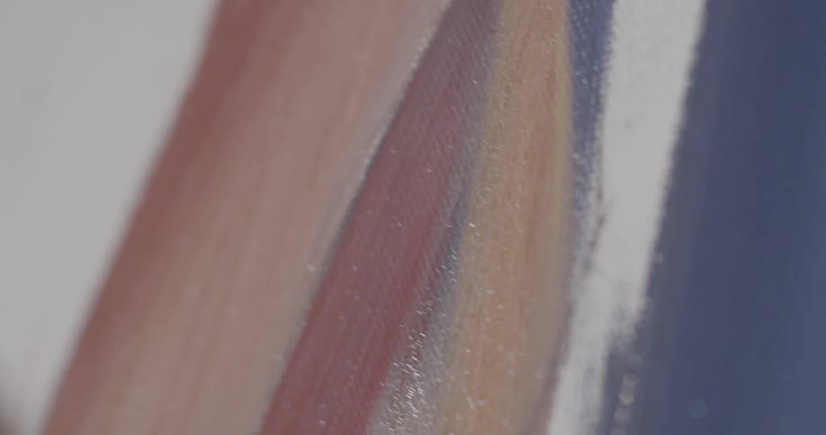Someone brushing red paint on to a canvas