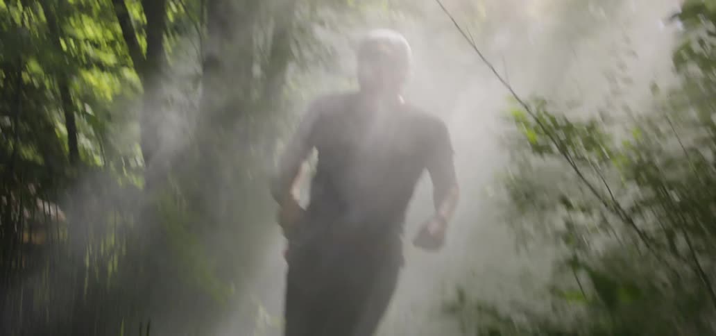 A man runs through the forest