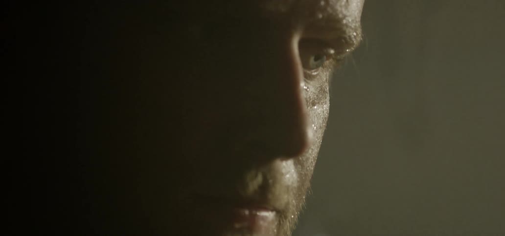 A white man sweats inside a room