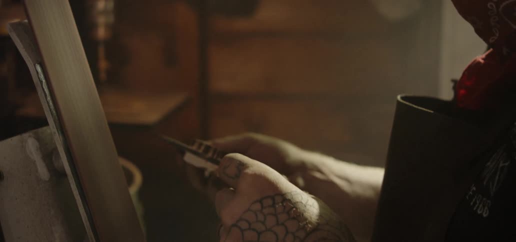 A young man examines a knife