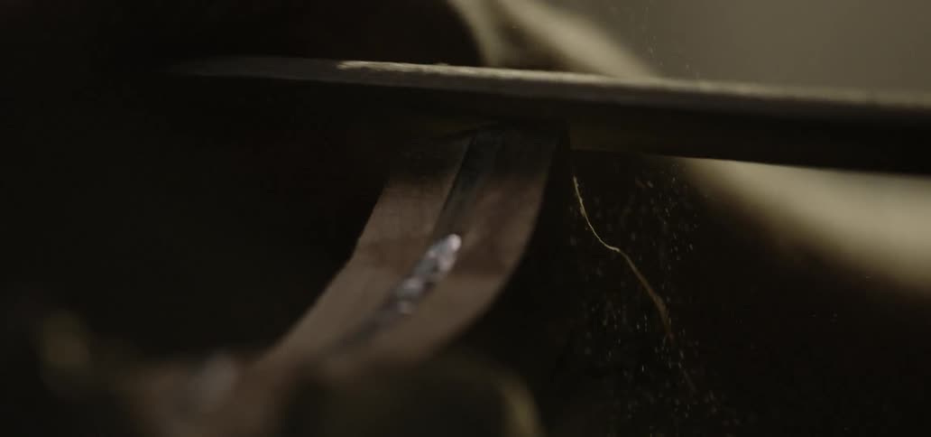 A man files the blade of a knife