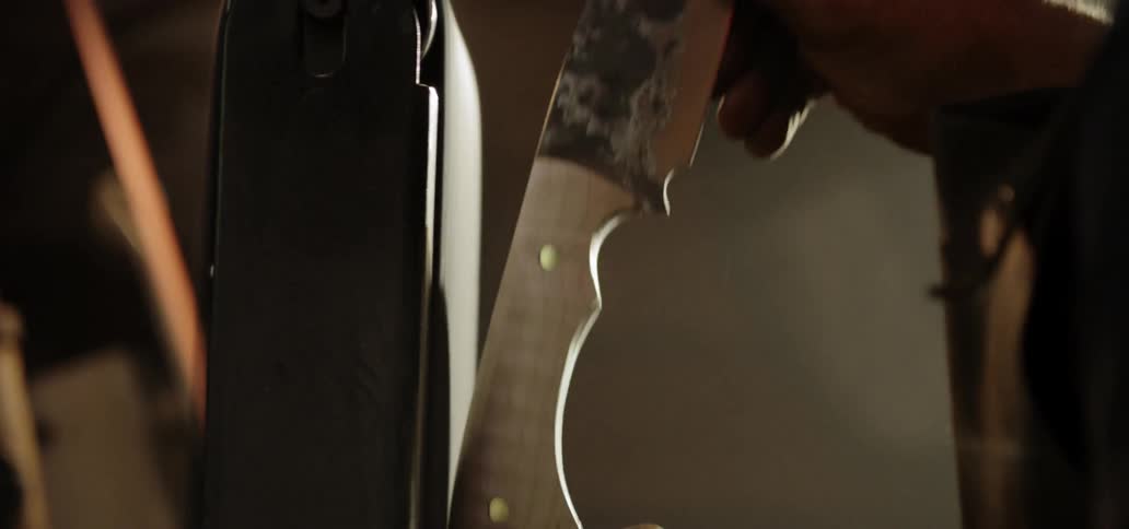 A man files a knife