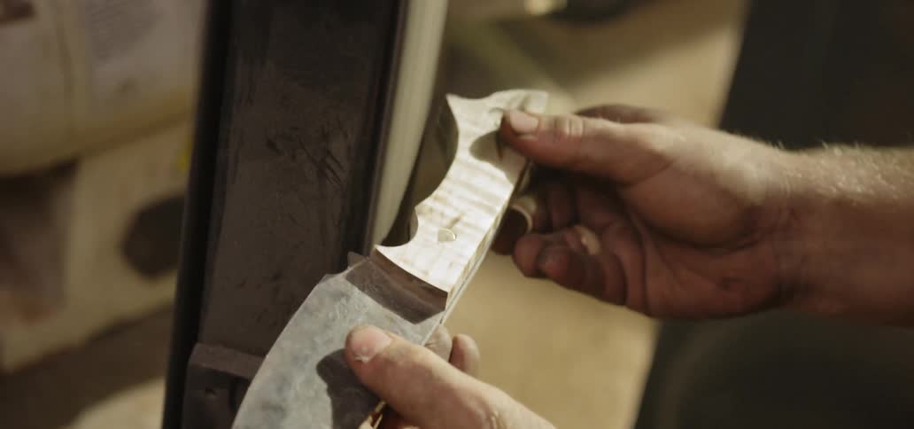 Man sharpens the knife in the workplace