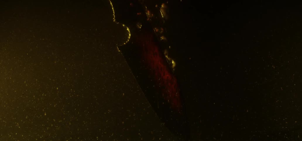 Glowing hot blade is quenched in water