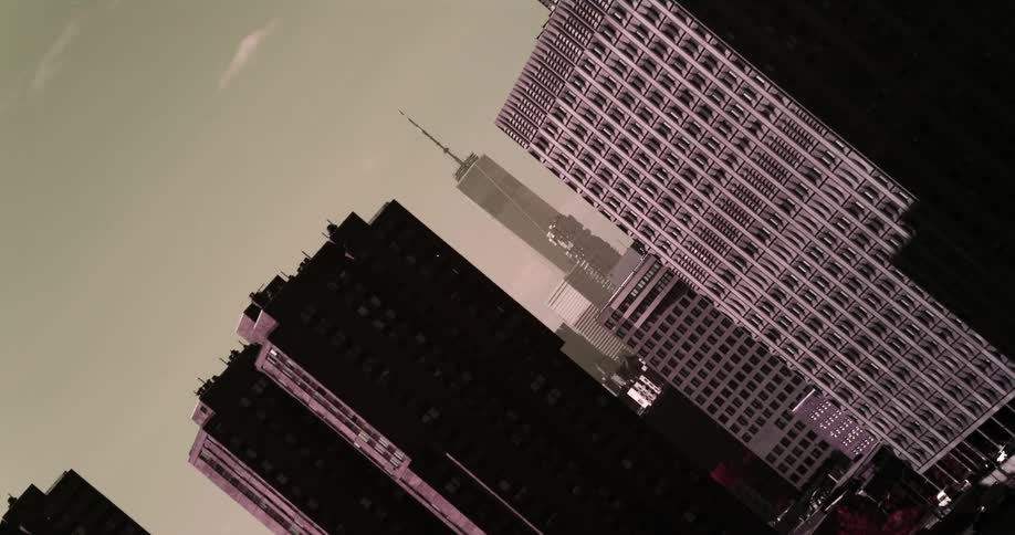 The buildings are tall and covered with fog