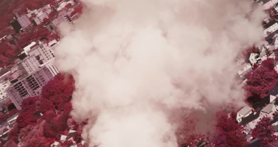 Smoke billows above a cityscape
