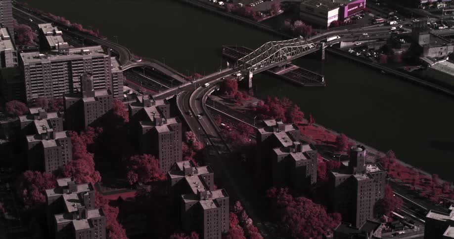 Cars travel on a city bridge over a river