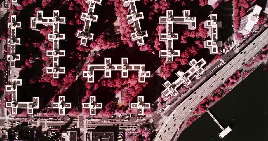 Birds eye view of cars driving down a freeway in a city
