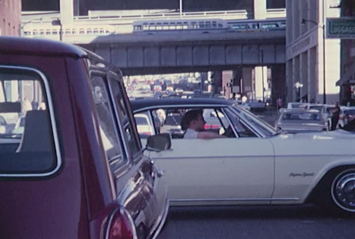Man sitting in the passenger seat of a car stopped in traffic