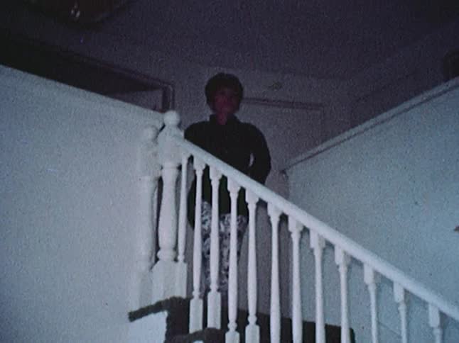 A woman struts down a staircase
