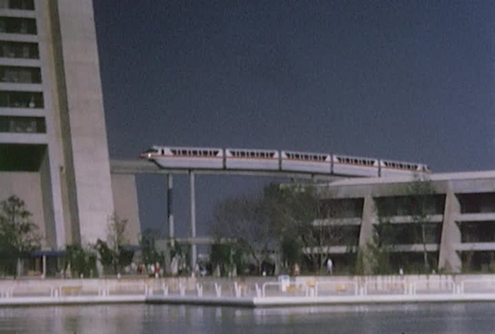 A monorail train travels on an elevated track