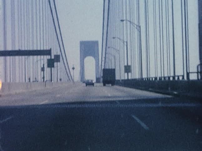 Old footage of a first-person view while driving over a large bridge