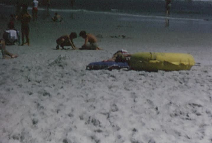Families enjoying the sand and surf at the beach
