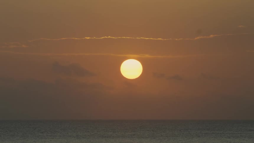 The sun above the ocean at sunset